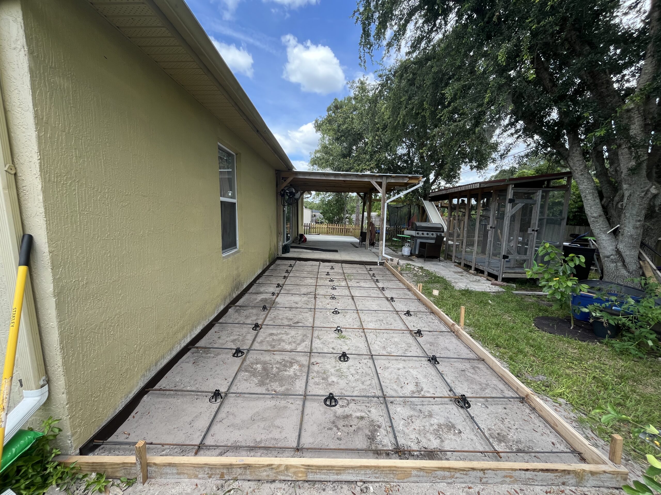 Concrete patio installation in Central Florida backyard by Tobinator Services